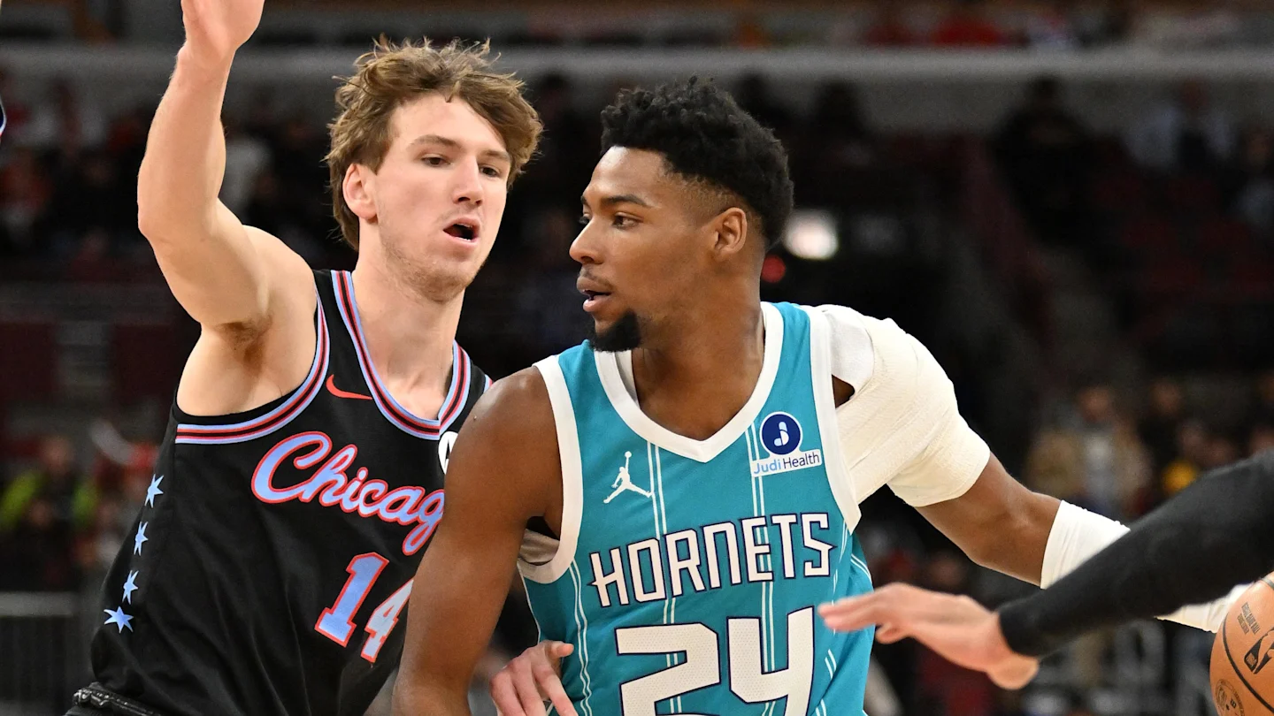 Major: 5 Key Things to Know About Bulls Hornets Last Game... 3 Chicago Bulls player raises his arm to contest a shot as a Charlotte Hornets guard looks on during a competitive NBA game.