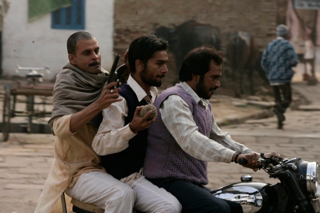Impact of 'Gangs of Wasseypur': A Cultural Examination 2 Gang members are shooting during an intense battle sequence